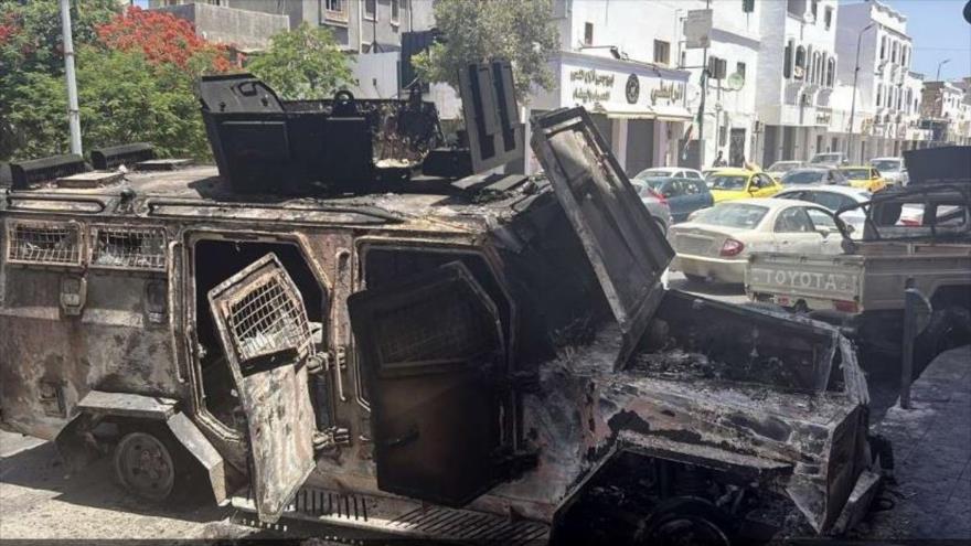 Vehículo blindado calcinado en medio de los enfrentamientos en Trípoli capital de Libia. FOTO de EFE publicada el 14 de mayo de 2025